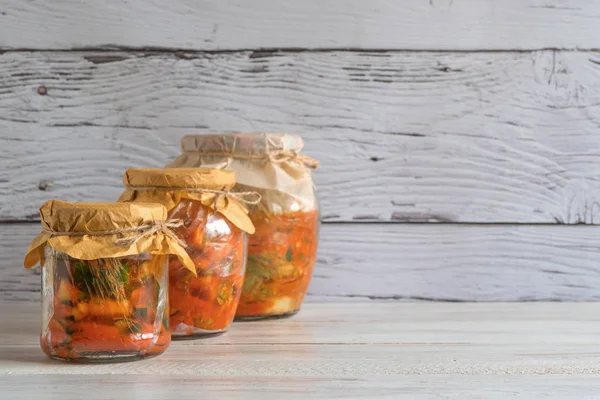 Korean kimchi in jars on a wooden table. — Stock Photo, Image