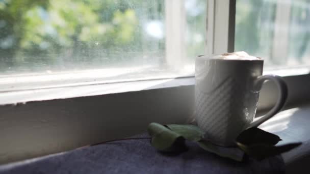 Taza blanca de café recién hecho delicioso primer plano en un día soleado, en un alféizar de la ventana — Vídeos de Stock