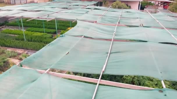 Awning that creates a shadow for cultivated plants and flowers. Aerial view. Canopy over an eco farm — Stock Video