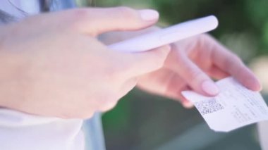 Qr Tarayıcı. Akıllı telefondan gelen bir çekteki kişi QR kodunu tarıyor, yakın plan. Mobil uygulama kullanarak mali muhasebe