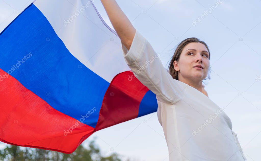 The symbol of Russia - flag in the hands of a woman. Independence and patriotism