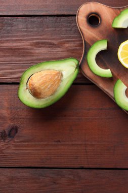 Avokado ahşap tahta üstte görüntülemek, avokado ve limon ahşap panoları, Vejetaryen gıda, sağlıklı Asya gıda, tropik meyveler kahvaltıda dilimlenmiş, alanı Kopyala