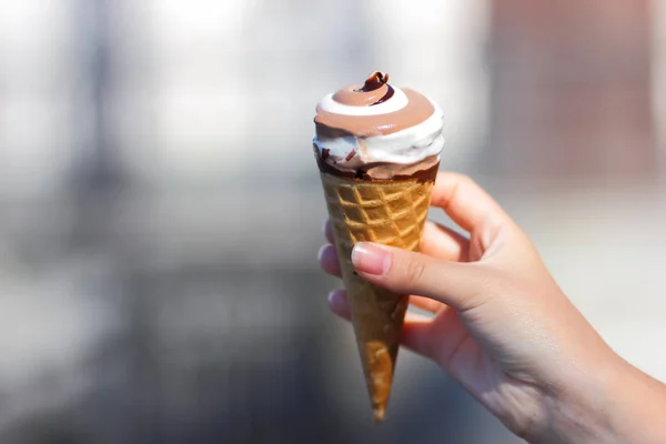 Ice cream cone, chocolate ice cream on blurred background, milk dessert on summer vacation, blank for designer, copy space, art