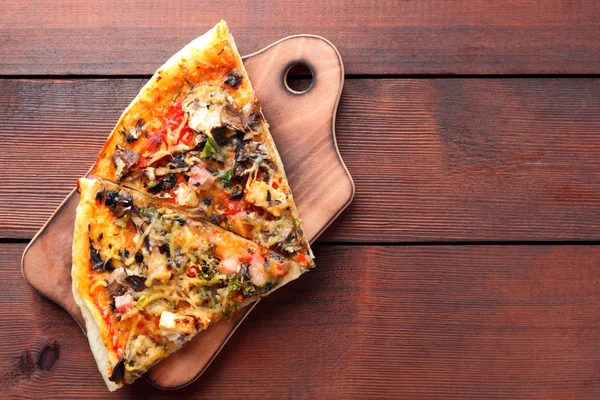 Pizza slices on a wooden board, Italian pizza on a wooden background top view, Italian food in vintage style, appetizing dish for summer vacation, American food, copy space, American food
