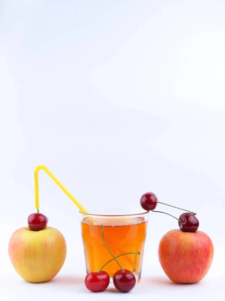 Fresh juice with apples and cherries, fresh apple juice on white background, healthy lifestyle, vegetarian drink, red berries with other fruits