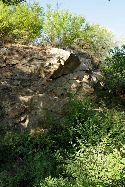 Granite rocks in the sun. Texture of granite stone. Background of natural material. Rocky rocks of ancient times. Minimalism