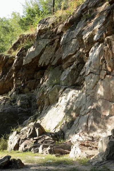 Granite rocks in the sun. Texture of granite stone. Background of natural material. Rocky rocks of ancient times