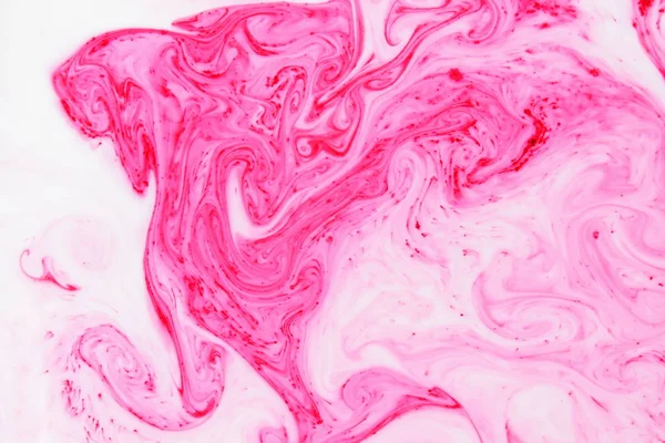 Fluid art. Color pattern on the liquid. Abstract colorful background. Pink pattern with the divorces on the liquid. Contemporary Art