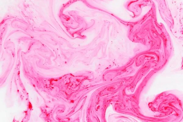 Fluid art. Color pattern on the liquid. Abstract colorful background. Pink pattern with the divorces on the liquid. Contemporary Art