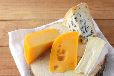 Peynir beyaz kumaş üzerine çeşitli türleri. Camembert, sert sarı peynir, dorblu ahşap kurullarında. Süt ürünleri Beyaz peçete üzerinde. Kopya alanı