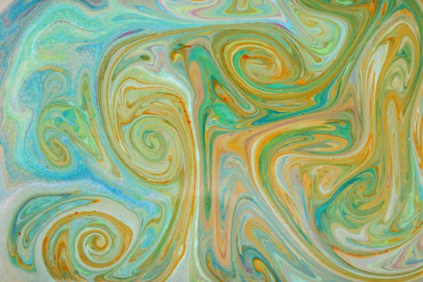 Abstract colorful background. Fine art in green color. Multicolored pattern on the liquid. Colored paint stains in the liquid. Art