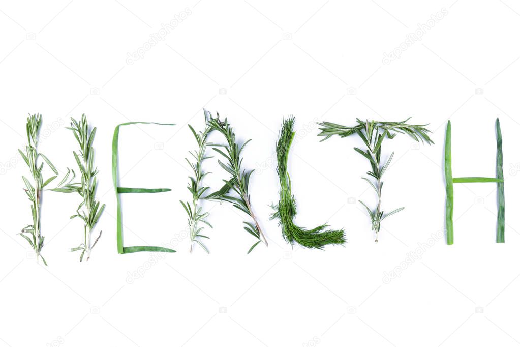 Word Health with green herbs. Dill, rosemary and green onions on white background. Word Health is isolated. Letters from natural products. Lettering