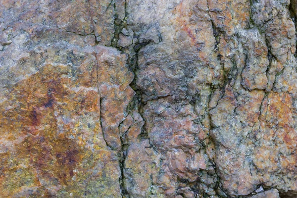 Granite texture close up. Granite rocks with porous surface. Background from solid stone. Pattern with natural material