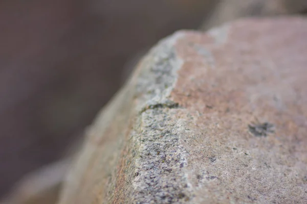 Granite rocks with blurred background. Granite close up. Texture of the stone. Natural material background