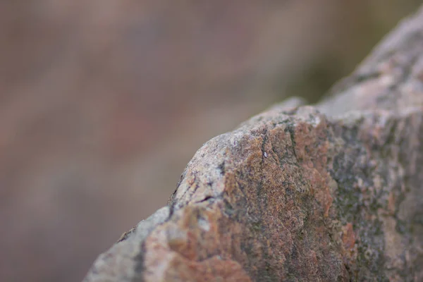 Granite rocks with blurred background. Granite close up. Texture of the stone. Natural material background