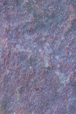 Granit dokusuna yakın çekim. Kırmızımsı renkli granit kaya. Sağlam taş kökenli. Doğal malzeme ile desen