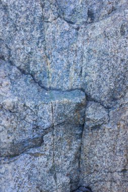 Granit doku kapatın. Gözenekli yüzey ile Granit kayalar. Sağlam taş kökenli. Doğal malzeme ile desen