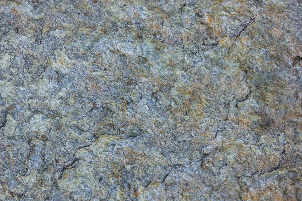 Granite texture close up. Granite rocks with porous surface. Background from solid stone. Pattern with natural material