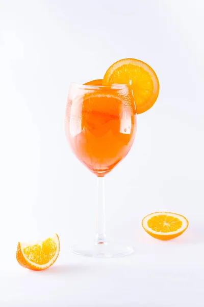 Cocktail aperol spritz on white background. Summer alcoholic cocktail with orange slices. Italian cocktail aperol spritz on white. Isolated