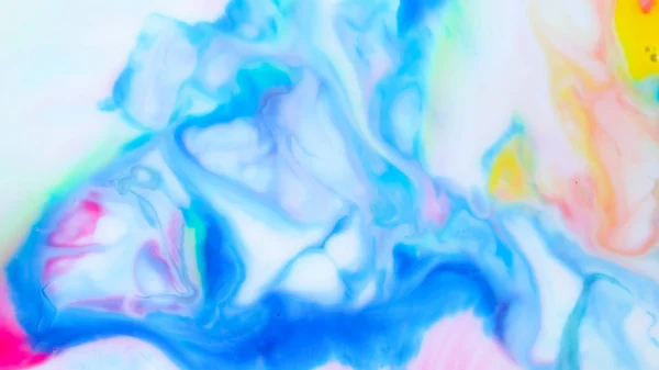 Multicolored background from paints on liquid. Fluid art with different colors. Screen saver. Bright pattern on liquid. Colored paint stains in pop art style