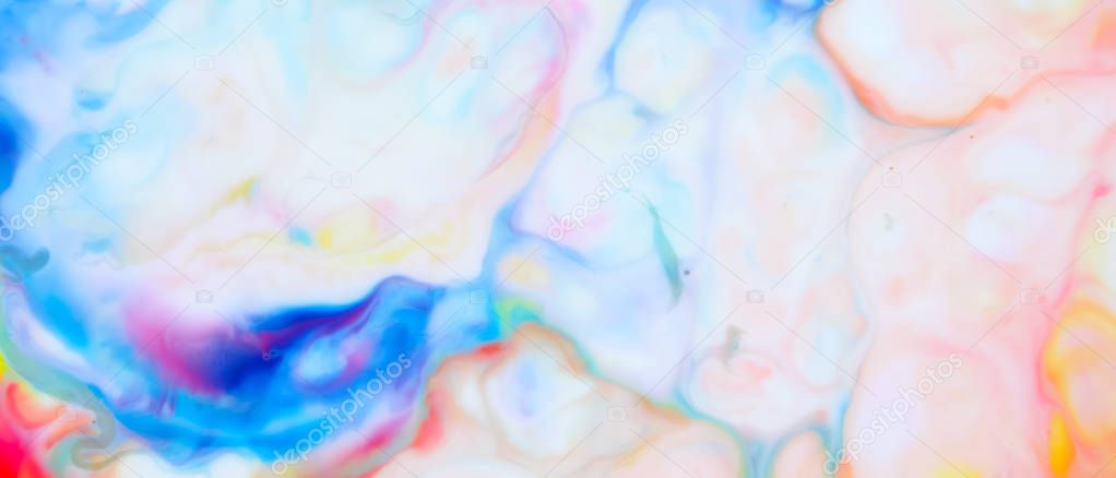 Multicolored background from paints on liquid. Fluid art with different colors. Screen saver. Bright pattern on liquid. Colored paint stains in pop art style