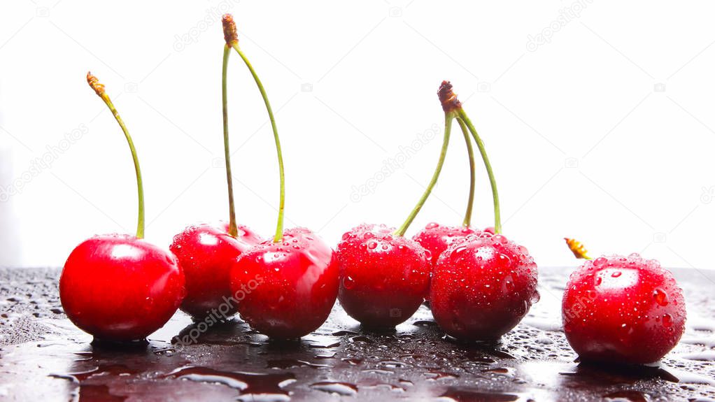 Red cherries in water drops. Fresh cherries on dark background. Berries for vegan. Washed cherries before cooking