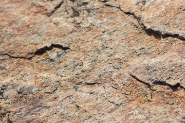 Granit taş dokusu. Granit in arka planı. Pürüzlü yüzey deseni. Kahverengi taş dokusu