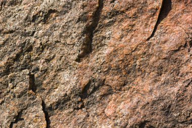 Granit in arka planı. Granit taş dokusu. Pürüzlü yüzey deseni. Kahverengi taş dokusu