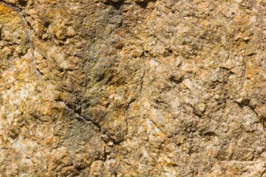 Granit in arka planı. Granit taş dokusu. Pürüzlü yüzey deseni. Kahverengi taş dokusu