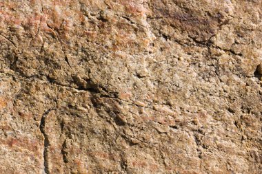 Granit in arka planı. Granit taş dokusu. Pürüzlü yüzey deseni. Kahverengi taş dokusu