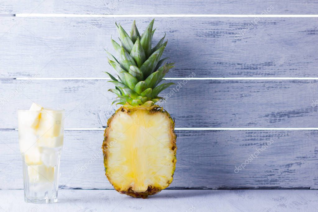 Drink with pineapple slices and ice. Pineapple and detox water on a white background. Tropical fruit with water. Healthy drink to cleanse the body. Copy space