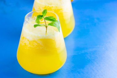 Mavi arka planda ananas kokteyli. Naneli soğuk ananas kokteyli. Yaz tropik kokteyli. Sağlıklı bir içki. Boşluğu kopyala