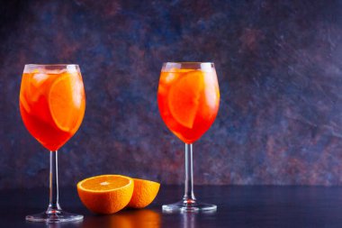 Koyu arkaplanda Aperol sprey kokteyli. İki bardak portakallı aperol spreyi. Bardakta yaz kokteyli. Boşluğu kopyala