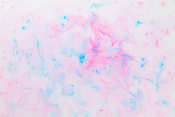 Fluid art texture. Pink blue background from liquid. Photography of colored spots on liquid. Abstract pattern