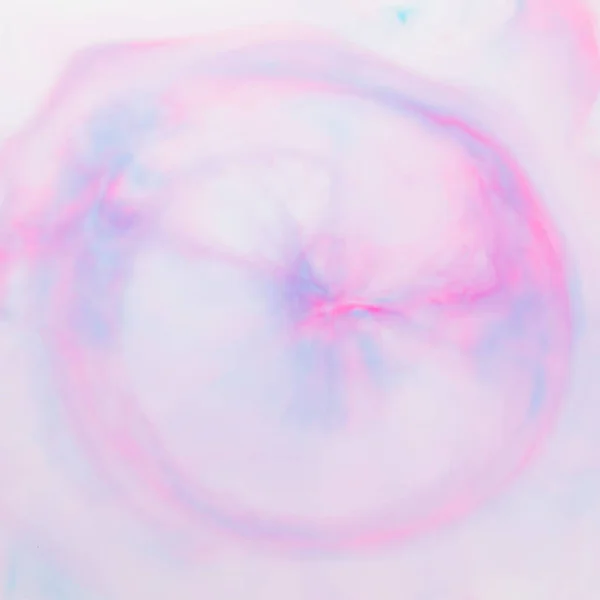 Fluid art texture. Pink blue background from liquid. Photography of colored spots on liquid. Abstract pattern