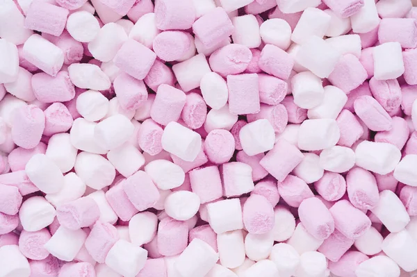 small white and pink marshmallows in the shape of cylinders for drinks and desserts decor - food background