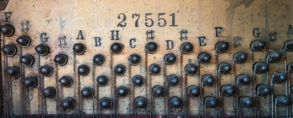 tuning screws of an antique piano close up