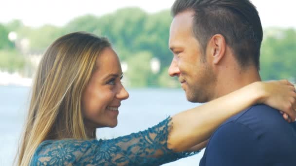 Un retrato de una pareja enamorada abrazándose y sonriendo delante de la cámara — Vídeos de Stock