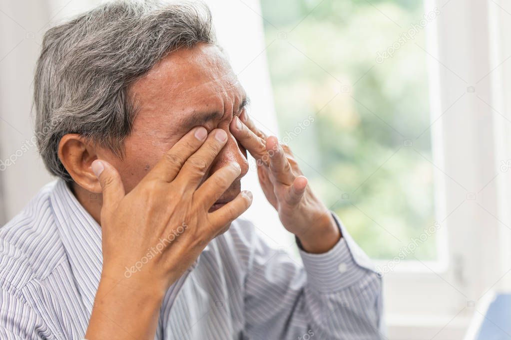 Asian Elderly Self Eye Soothing Massage from irritation problem fatigue and tired after hard work or computer vision syndrome