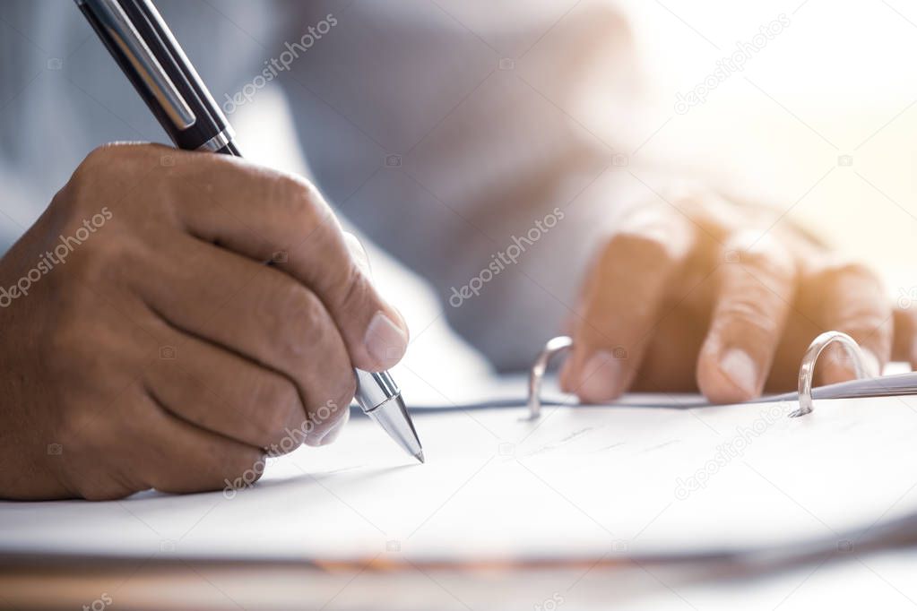 Closeup male senior hand writing Sign contract document concept