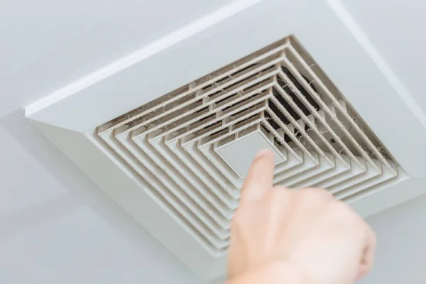 Finger Pointing Dusty Dirty Ceiling Air Ventilation Fan Hole Grill — Stock Photo, Image