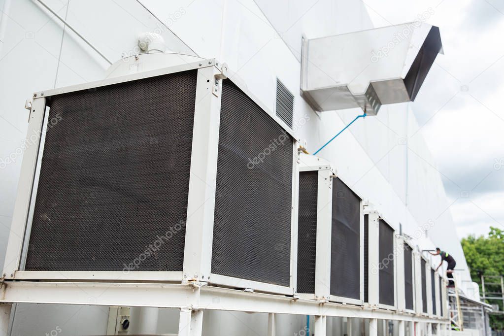 Air vent pipe with row of Air conditioning system chiller outside supermarket building