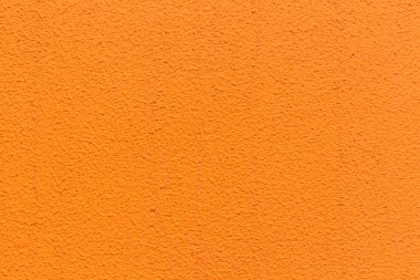 Turuncu sıva duvar doku deseninin arka planı için.