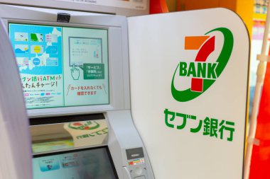 Seven Bank, Japanese bank by Seven & I Holdings ATMs money service installed at 7-Eleven stores in Japan, Osaka, 18 January 2019. clipart