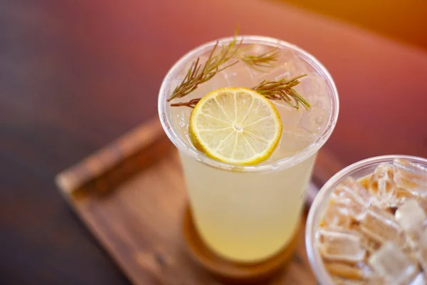 ice lemon soda juice on wooden table. fresh fruite drink for hot summer season.