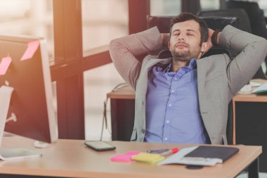 businessman relaxing rest nap after hard work day in the office clipart