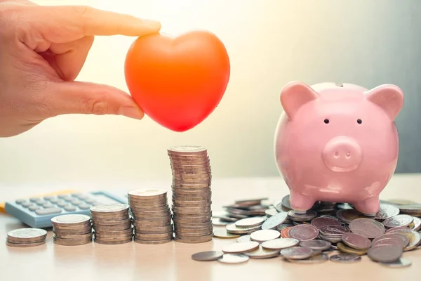 Love Heart and Saving Money Piggy Bank for Life insurance Share or Donation concept.