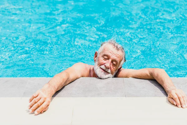 old man athlete exhausted from swimming on a hot day summer season.