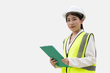 Asyalı genç kadın mühendis portresi çelik yelek giysisi kabzası sapı kontrol listesi mutlu bir gülümseme beyaz arka planda kırpma yolu ile izole edilmiş.