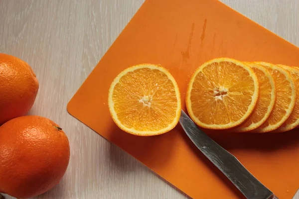 Orange, cut circles lies on the board.